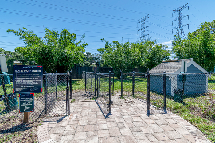 Go park with lush greenery and a dog house