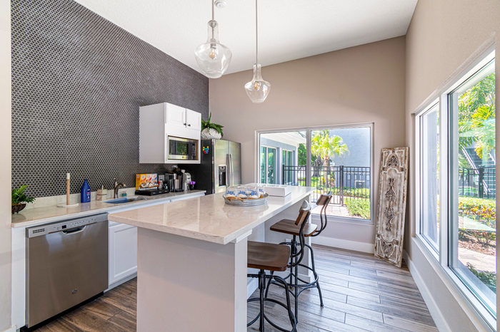 Resident lounge kitchen area with bar and bar chairs