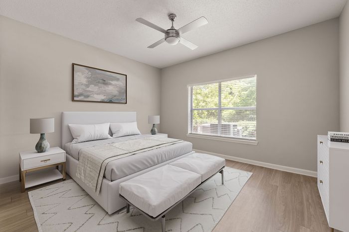 Bright and airy bedroom with a large window, modern decor, and cozy ambiance.