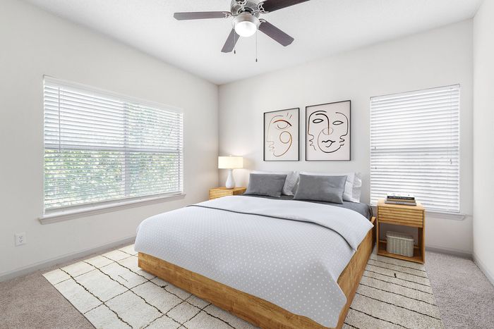 Bright and stylish bedroom featuring a cozy bed with modern art on the wall, elegant blinds, and soft lighting.