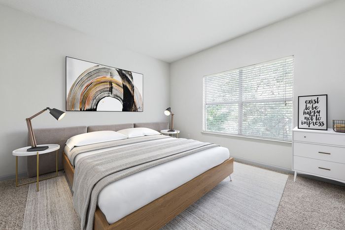 Bright and inviting modern bedroom with cozy furnishings, featuring a large window that floods the space with natural light.