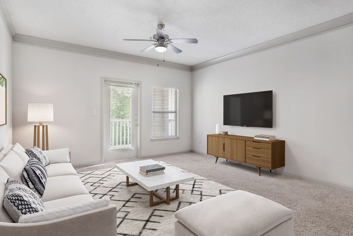 Bright and airy living room featuring modern decor, a comfortable sofa, chic patterned cushions, and a wall-mounted TV.