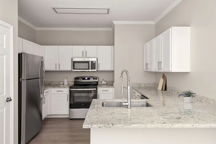 Modern kitchen with sleek stainless steel appliances, elegant countertops, and white cabinetry offering a sophisticated culinary experience.