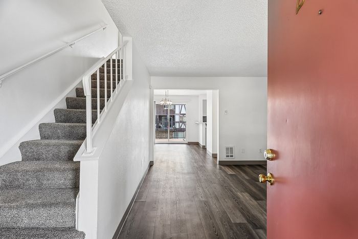Entry to the apartment with carpeted stairs