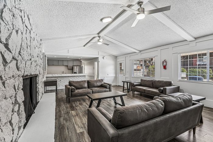 Modern clubhouse with full kitchen and lounge area around the fireplace
