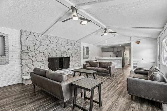 Modern clubhouse with full kitchen and lounge area around the fireplace