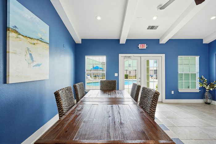 Business center with computers, desk space, and modern amenities at Portside Villas in Ingleside, TX
