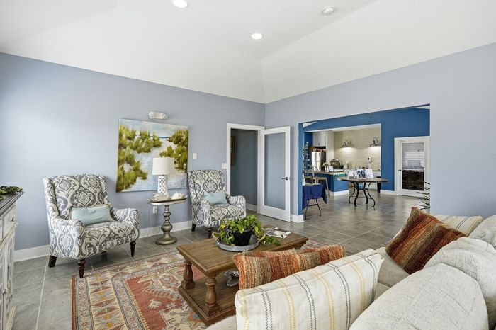 Spacious clubhouse with a comfortable sofa, beautiful area rug, and entertainment center at Portside Villas, Ingleside, TX
