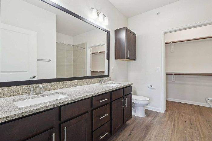Dual Vanities in bathroom with walk in closet