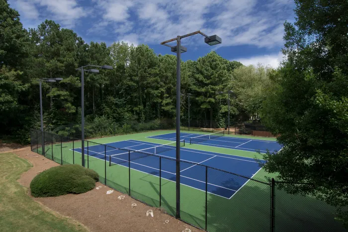 Outdoor multi-sport court with basketball hoops and tennis lines at Avenues of Kennesaw