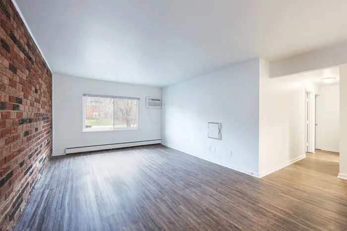 Contemporary, spacious living room with open layout. Large window allows natural light to fill the space with a restored brick wall giving the space a contemporary feel. Apartments for rent in Dayton, OH near University of Dayton.