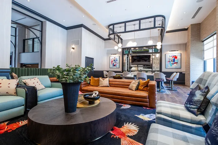 Luxurious open-concept living space with elegant furniture, vibrant decor, and a stylish dining area, perfect for modern living and entertaining.