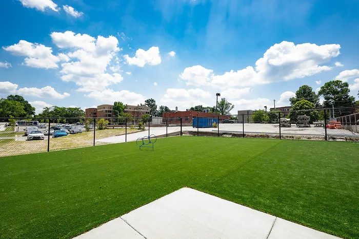 Inviting outdoor space with lush green turf and scenic views, ideal for relaxation and recreation under a vibrant blue sky.