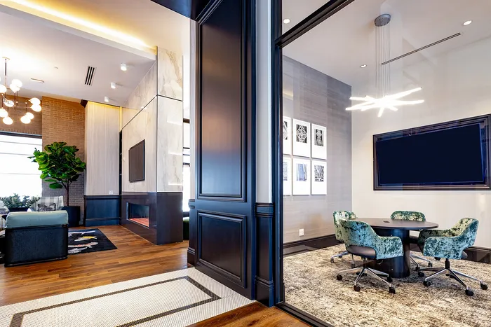 Contemporary living space with chic decor, cozy seating area, stylish modern lighting, and artistic wall frames, perfect for a luxurious urban lifestyle.