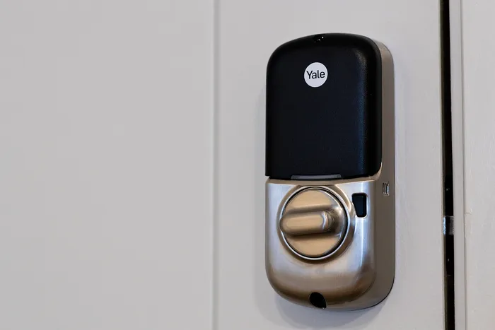 Sleek smart door lock with modern silver and black design, enhancing security and style.