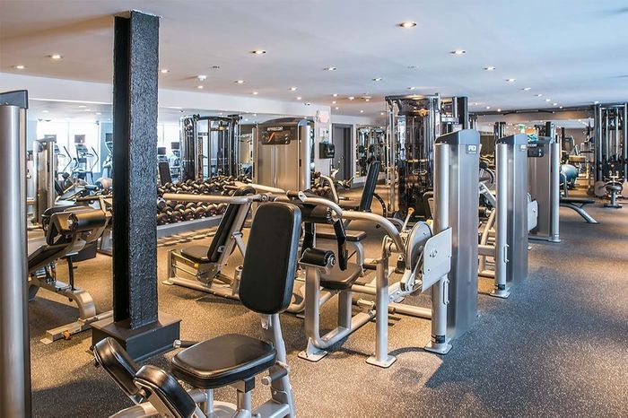 fitness center with cardio and weight lifting equipment, floor to ceiling mirrors