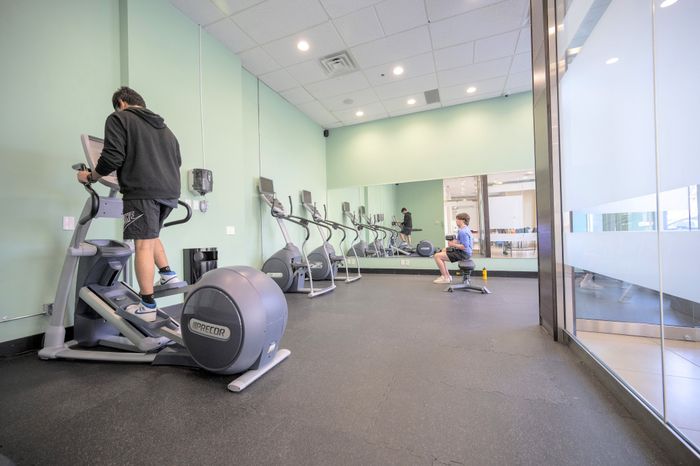 Modern fitness center equipped with high-quality elliptical machines and a vibrant atmosphere for an energetic workout.
