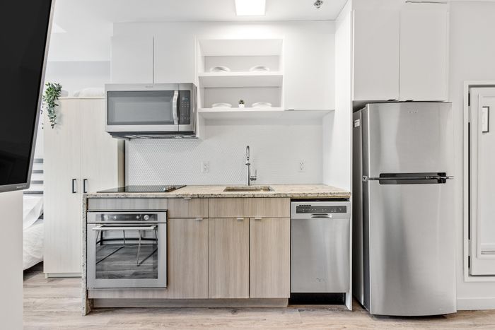 Modern kitchen with sleek stainless steel appliances, elegant cabinetry, and minimalist design.