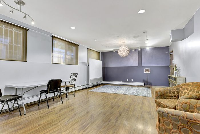 Spacious modern apartment with sleek hardwood floors, elegant lighting, and flexible living space, perfect for stylish entertaining.
