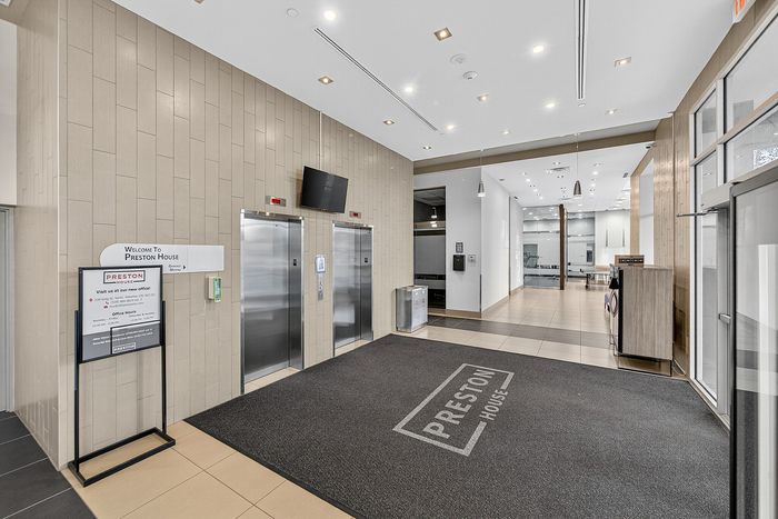 Elegant Preston House lobby featuring sleek elevators, modern design, and inviting atmosphere.