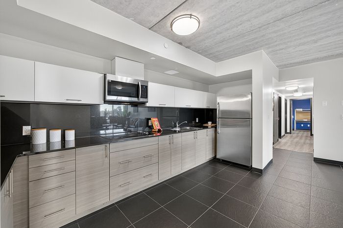 Contemporary kitchen design featuring sleek cabinets, modern appliances, and a spacious layout in a stylish apartment.