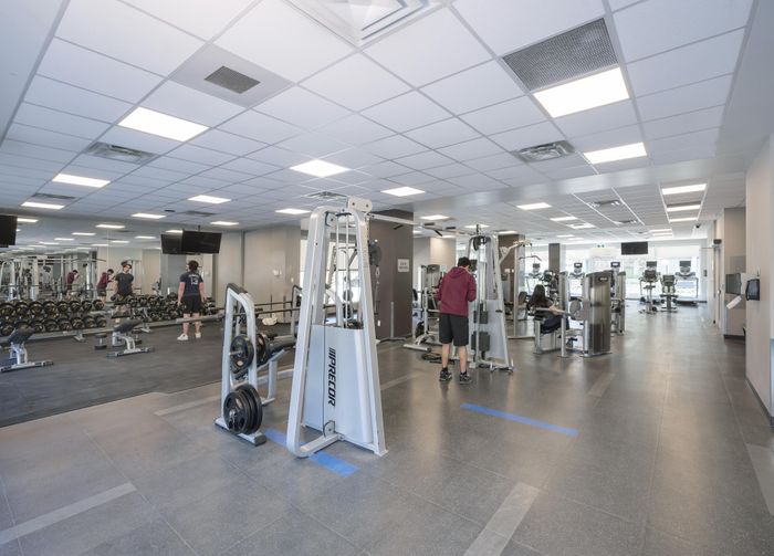 Spacious and modern gym with state-of-the-art equipment, perfect for fitness enthusiasts seeking a dynamic workout experience.