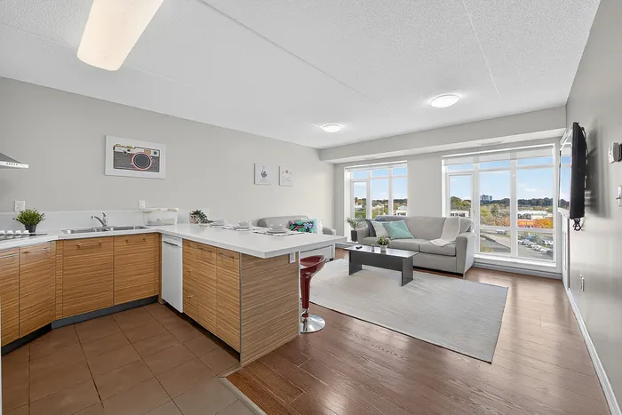 Bright open-concept living space with a modern kitchen island, sleek cabinetry, and expansive windows offering stunning views.