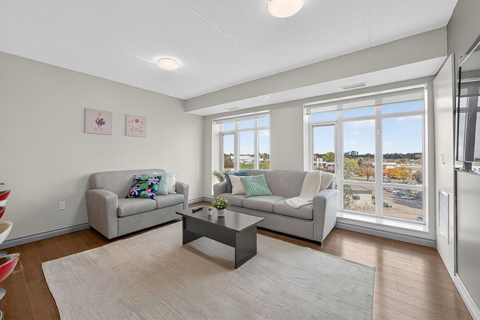 Bright and inviting living room with modern furniture, large windows offering a scenic view, and stylish decor accents.