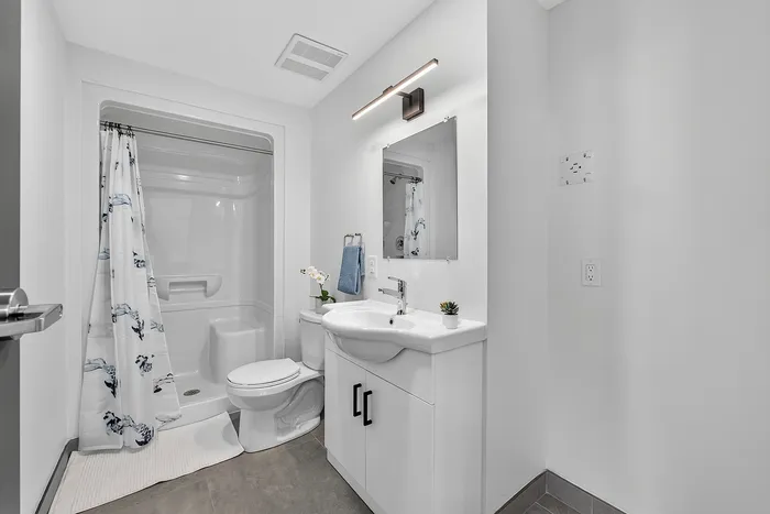 Elegant modern bathroom with sleek fixtures, stylish vanity, and a bright, airy ambiance.