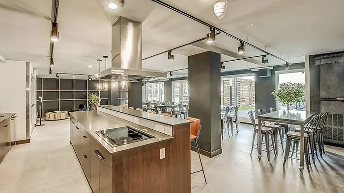 Modern and spacious kitchen with sleek countertops, stylish lighting, and ample seating for dining and entertaining.