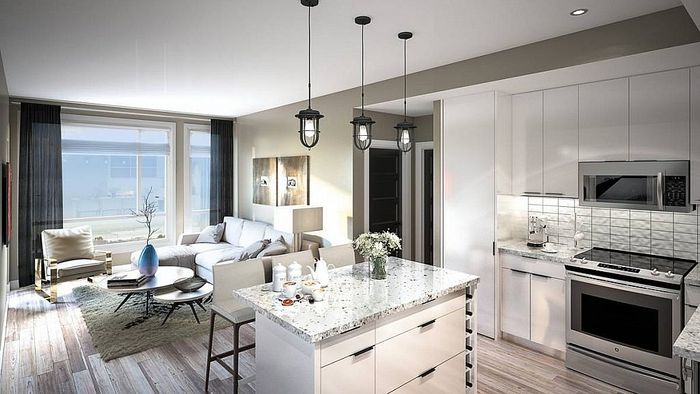 Contemporary open-plan living room and kitchen with sleek design, featuring a chic sofa, marble countertops, and modern appliances.