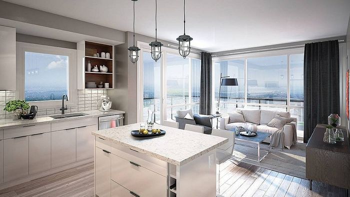 Modern open-plan kitchen and living area with sleek design, large windows offering panoramic views, and abundant natural light.