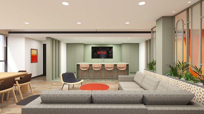 Modern living room with chic decor, a plush gray sectional sofa, stylish dining area, and sleek kitchen island with bar stools, perfect for entertaining.