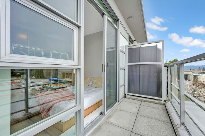 Modern balcony with glass panels offering a bright and airy view into a cozy bedroom, perfect for enjoying serene outdoor moments.