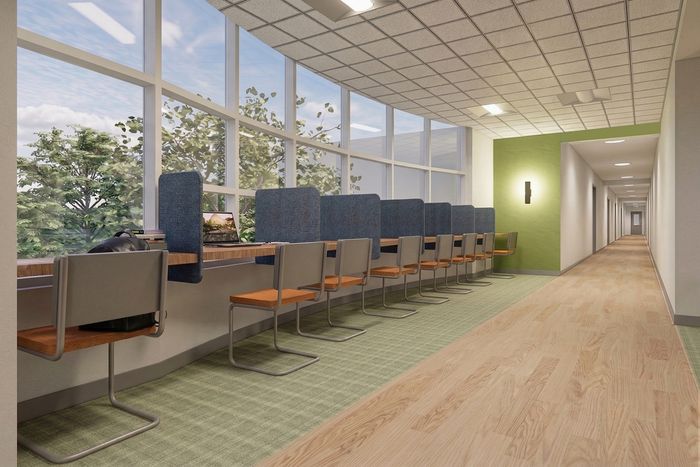 Inviting modern study area with comfortable seating, large windows offering natural light, and scenic views.