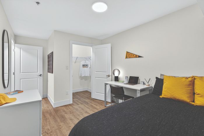 Modern student bedroom with sleek furniture, a cozy bed, and stylish workspace, perfect for productivity and relaxation.