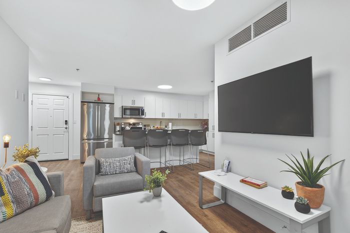 Modern open-plan interior with a sleek living room, stylish kitchen, and contemporary decor, showcasing a perfect blend of comfort and elegance.