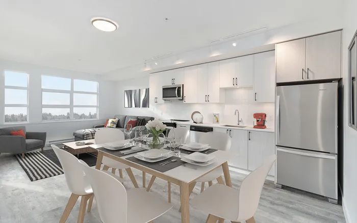 Modern open-concept kitchen and living area with sleek appliances, elegant dining setup, and panoramic windows offering stunning views.