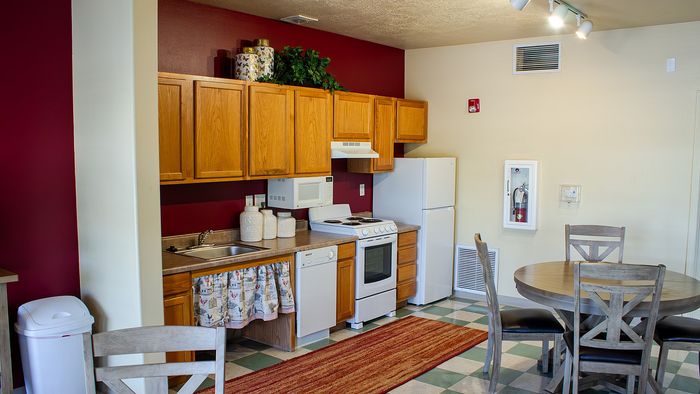 Metro Flats community kitchen and dining area with seating and appliances