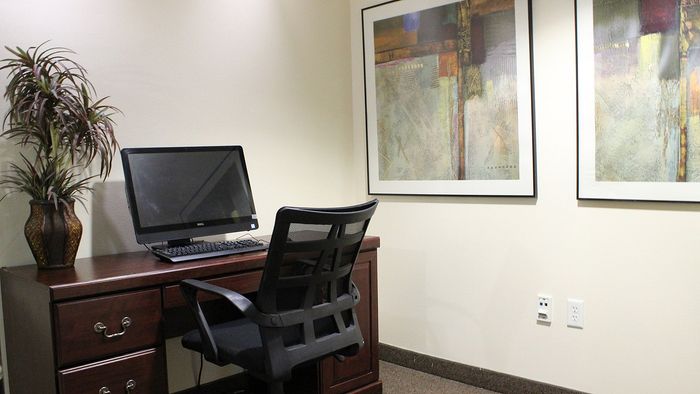 Metro Flats business center with computer workstation and workspace