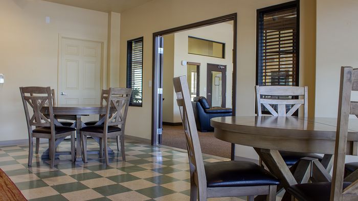 Metro Flats clubroom with dining tables and community gathering space