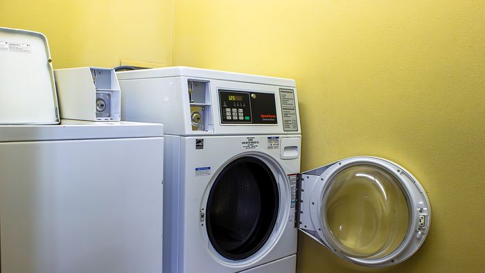 Metro Flats laundry room with community washer and dryer machines