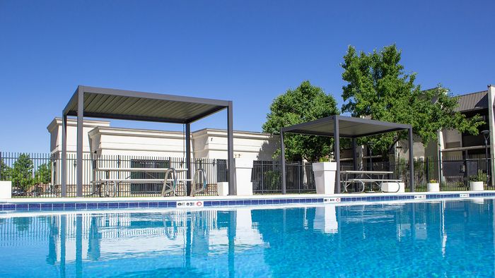 Outdoor pool with lounge seating at The Oslo apartments in Murray, Utah