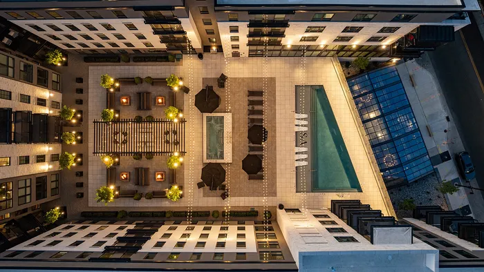 Overhead shot of Sugar Alley rooftop pool deck with string lights at night