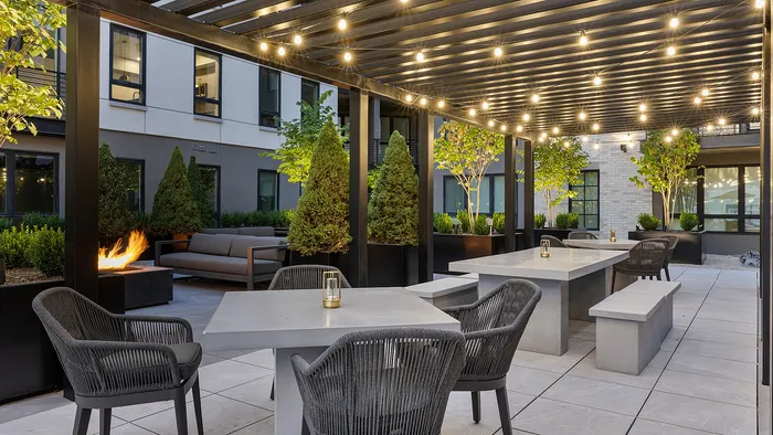 Sugar Alley rooftop pergola lounge area illuminated by hanging lights