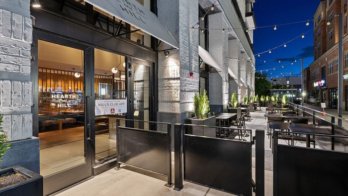 Hearth and Hill restaurant at Sugar Alley with exterior dining area at night