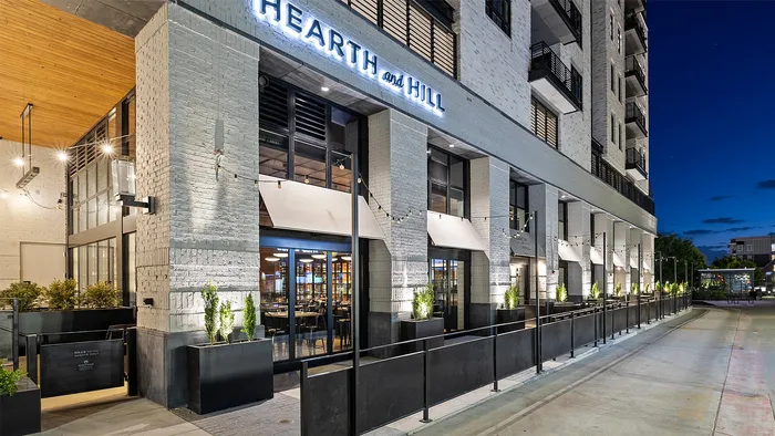 Outdoor patio seating of Hearth and Hill at Sugar Alley with ambient lighting