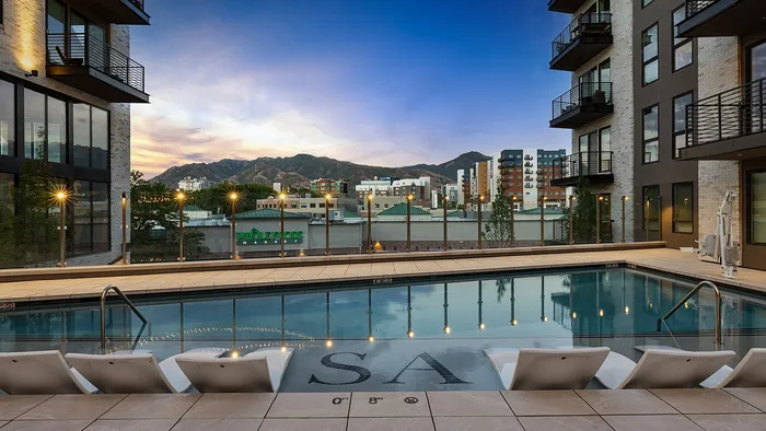 Sugar Alley rooftop pool glowing in the evening light with hanging string lights