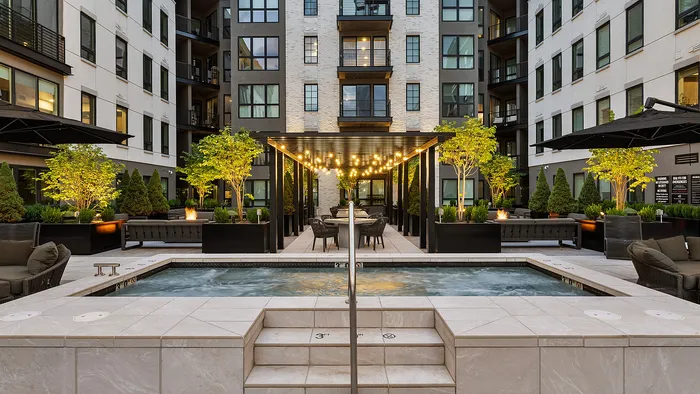 Sugar Alley rooftop hot tub at night with modern lighting