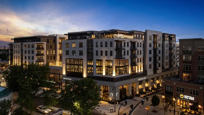 Side angle of Sugar Alley building at night with Hearth and Hill restaurant in view